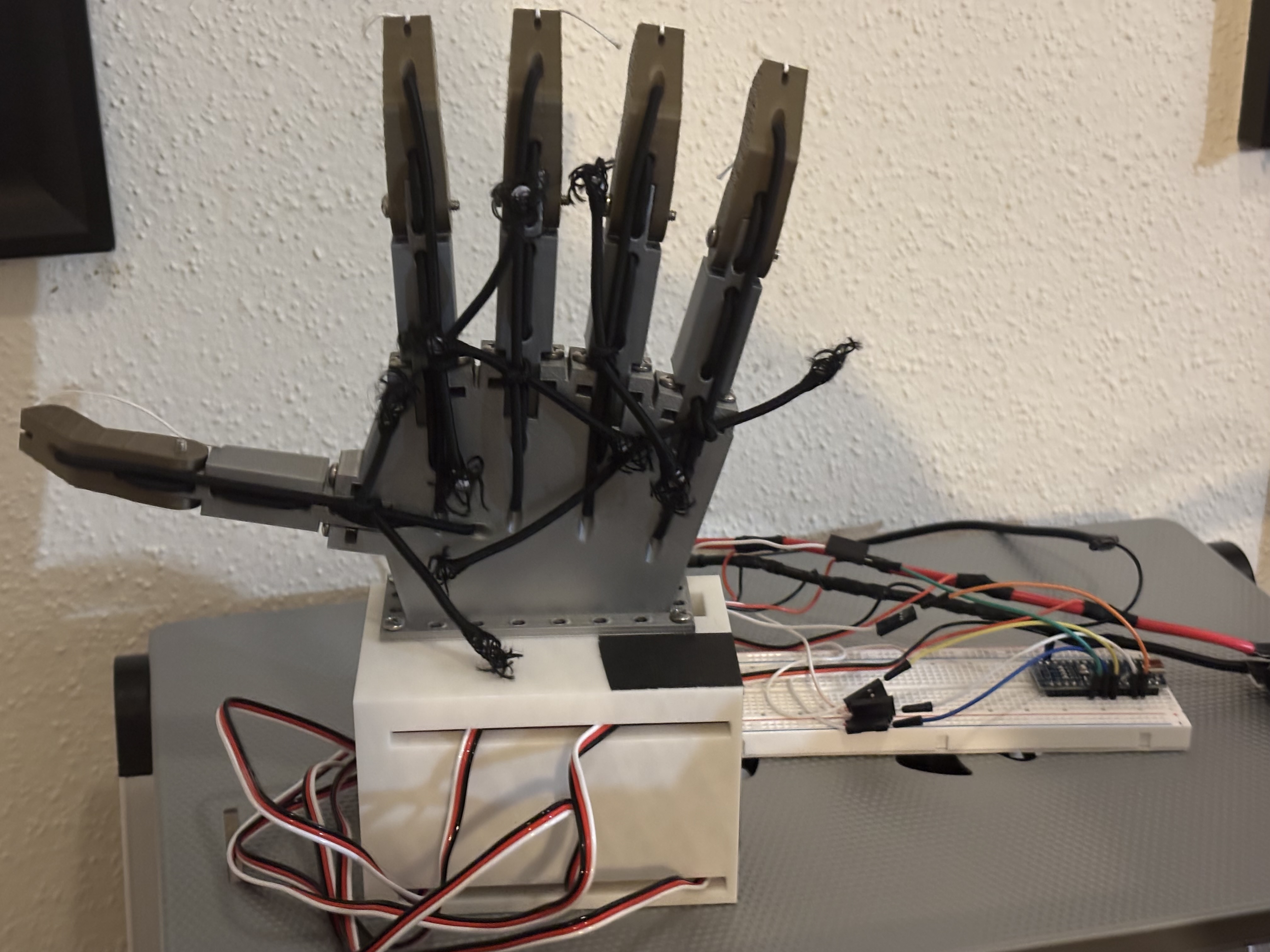 Back-side view showing the robotic hand structure and routing